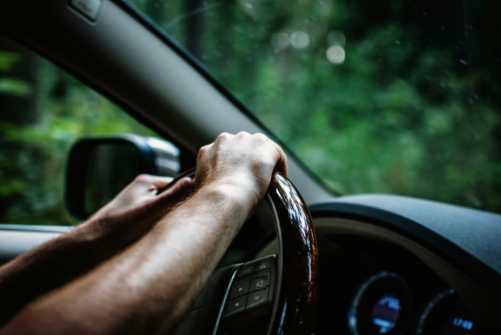 person holding car steering wheel, SR-22